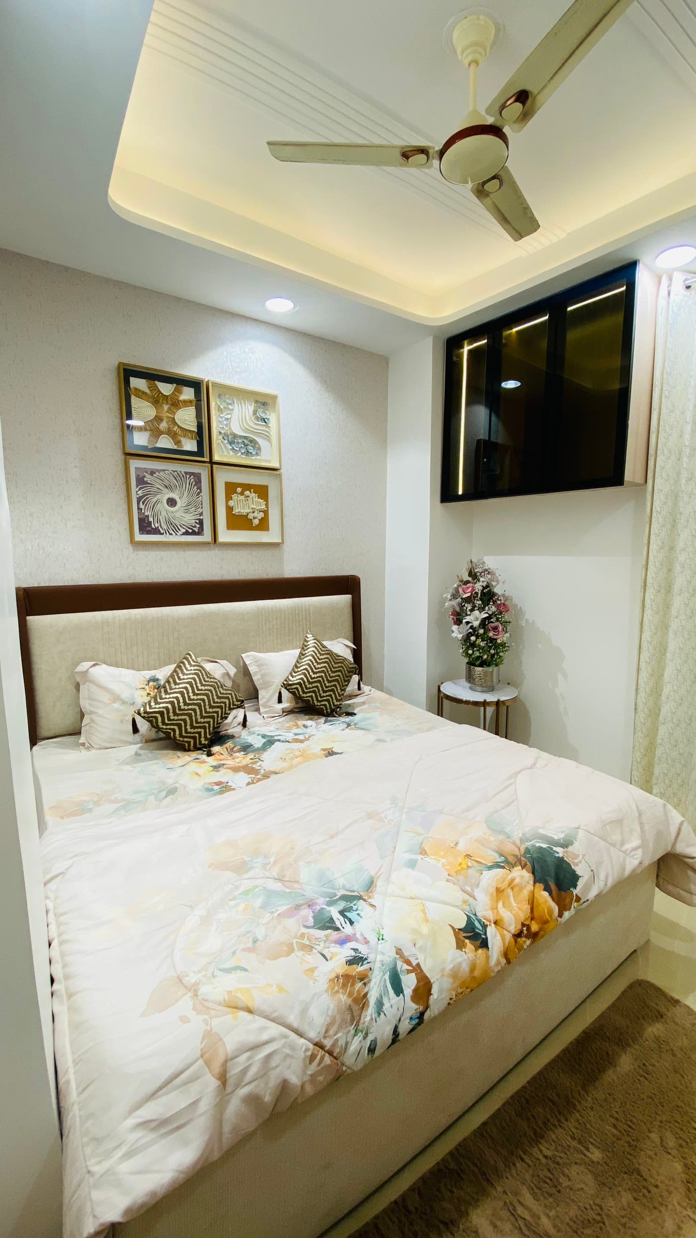 Bedroom with upholstered bed and false ceiling