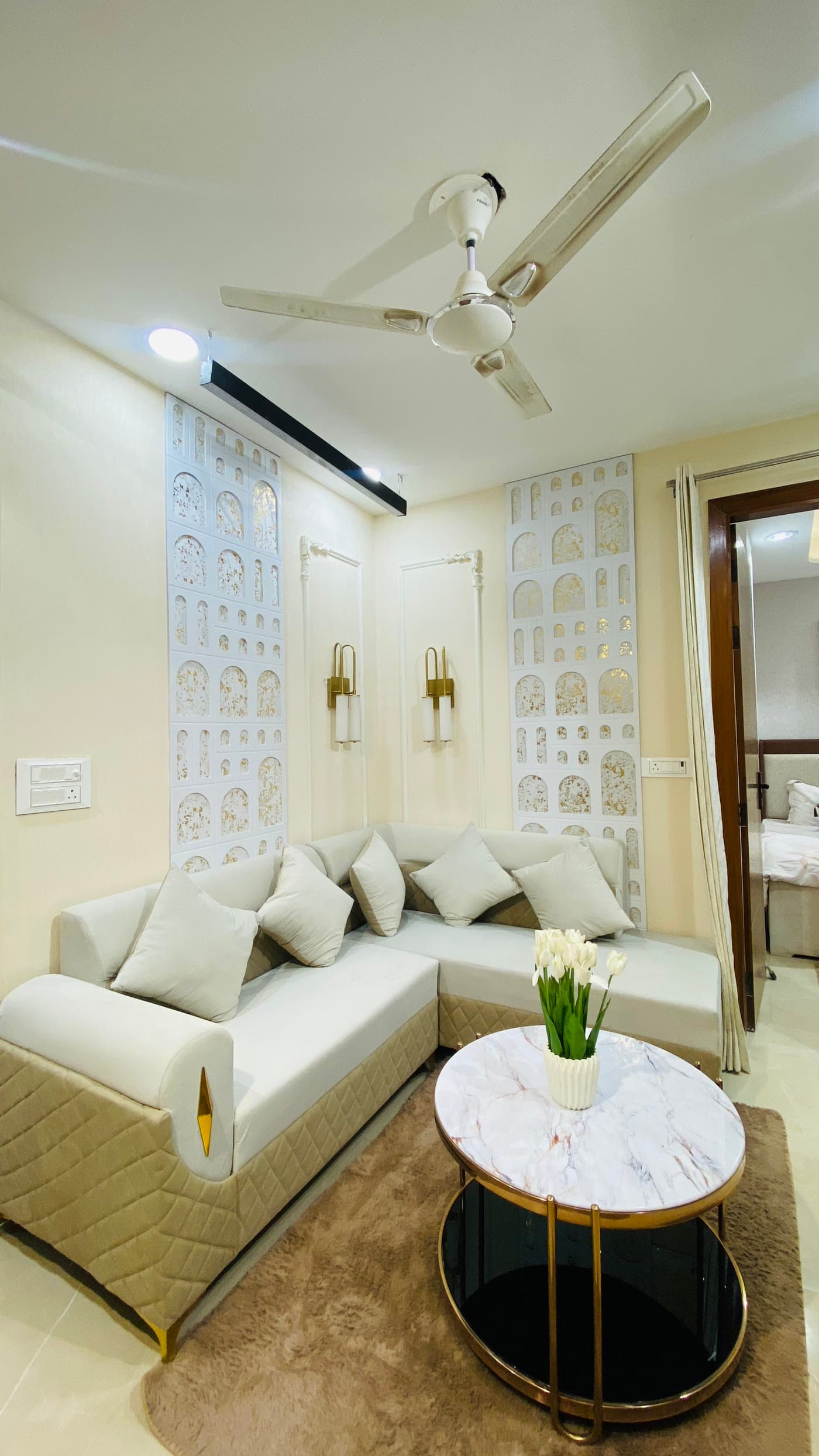 Living room with L-shaped sofa and jaali panels